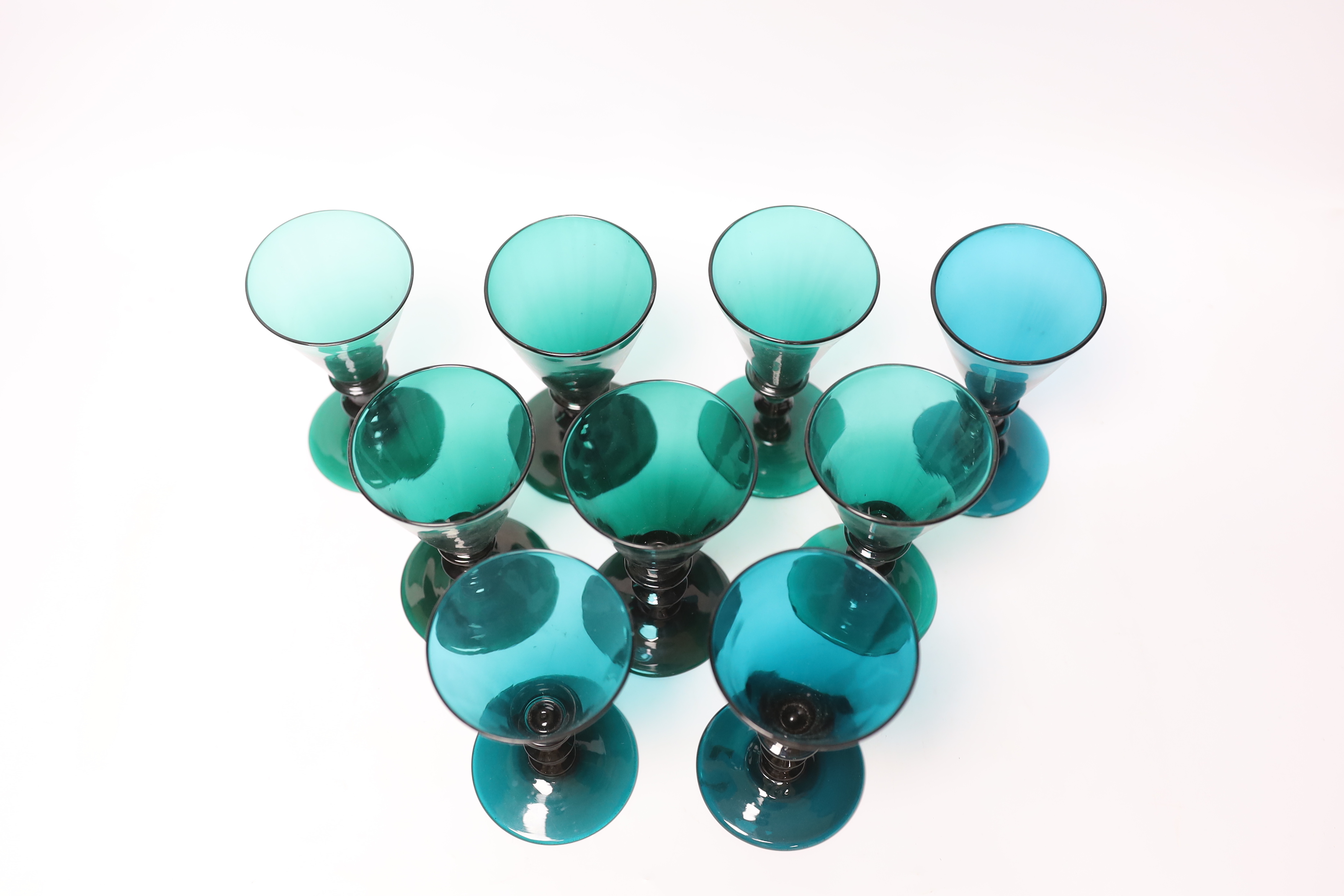 Nine early 19th century green wine glasses, 14cm